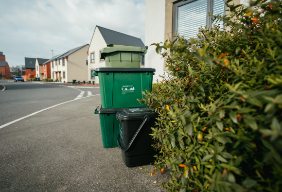 Selection of recycling bins boxes and food waste bin, on a residential pavement