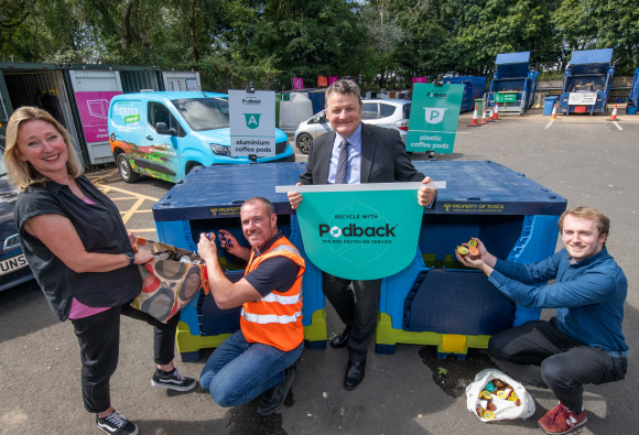 4 staff gathered around a coffee pod collection bin at a HWRC
