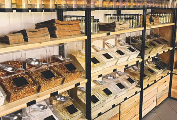 Refill shop shelves of produce in jars and containers